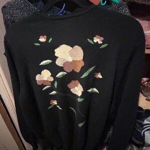 Black floral sweater with cut neck